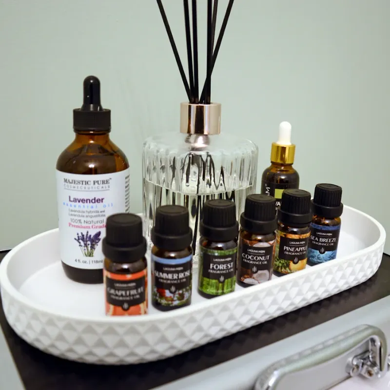 A tray of essential oils and a reed diffuser at May Breeze Spa