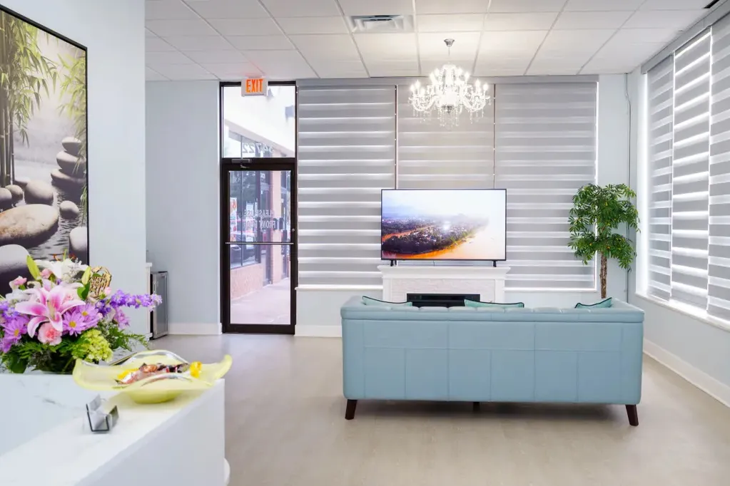 The reception lounge at May Breeze Spa on Plymouth Rd, with seating, flowers and daylight from the street windows
