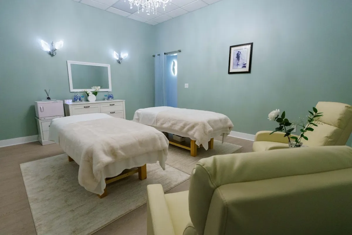 The couple's room at May Breeze Spa with two massage beds, a sofa and a chandelier